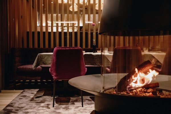 Offenes Kaminfeuer in einem modernen Restaurant mit gedeckten Tischen
